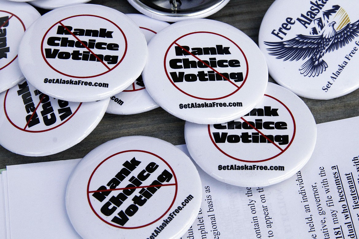 Campaign buttons urging Alaskans to repeal ranked choice voting in Alaska sit on a picnic table at the home of Phil Izon, a backer of the initiative, in Wasilla, Alaska, on Tuesday, May 14, 2014 Arguments are scheduled May 28, 2024, in a lawsuit challenging the state Division of Election's decision to certify the initiative for placement on the ballot this year. (AP Photo/Mark Thiessen)