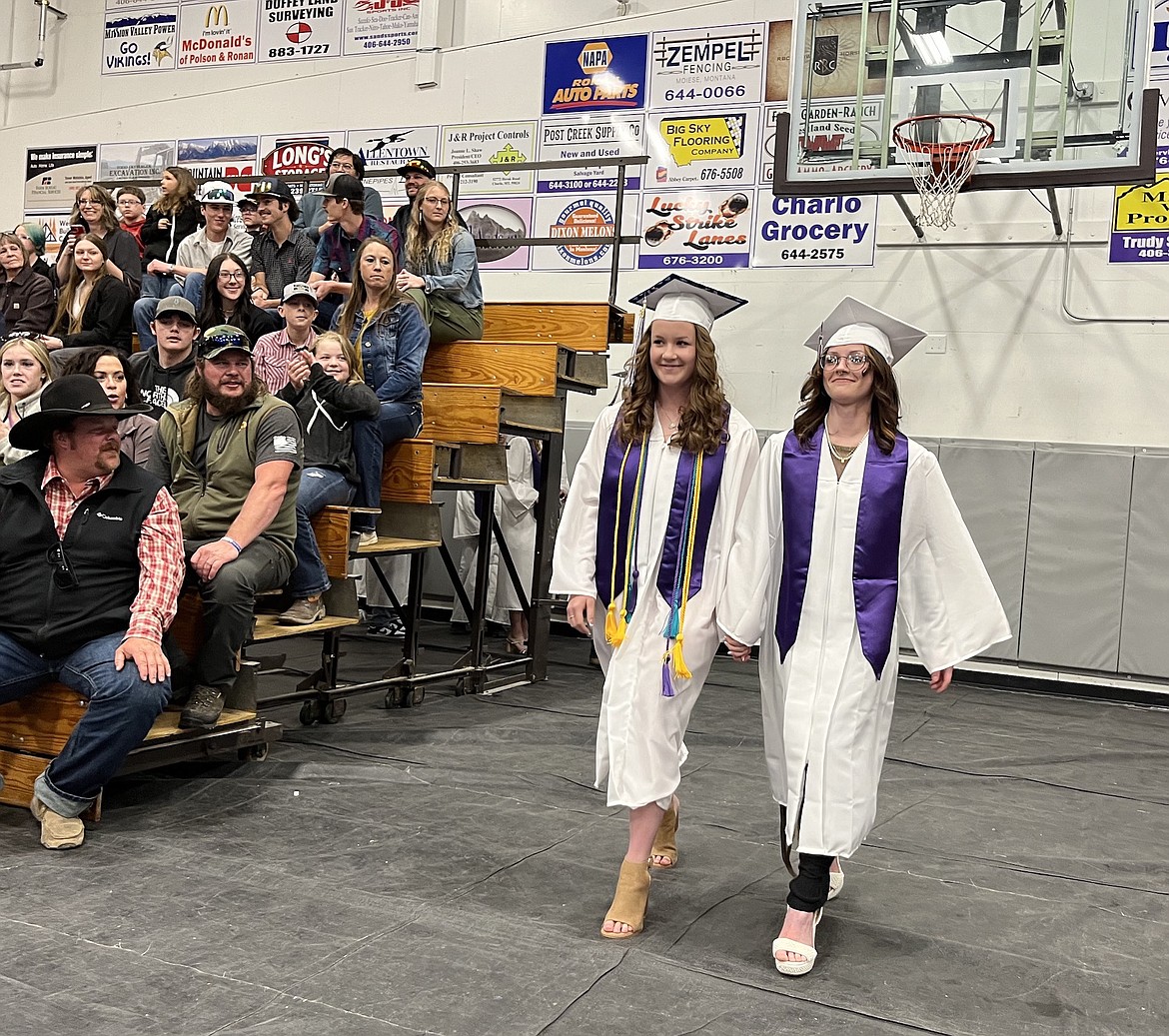 Aubry Sharbono and Taylea Lund begin their commencement march during Charlo High's graduation ceremony, held Sunday. (Kristi Niemeyer/Leader)