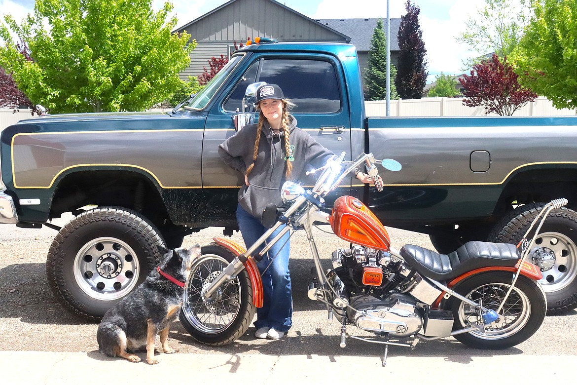 Keaton Lee with her 1990 Dodge Ram, 1972 Ironhead Harley and her blue heeler Bandit, at her Post Falls shop.