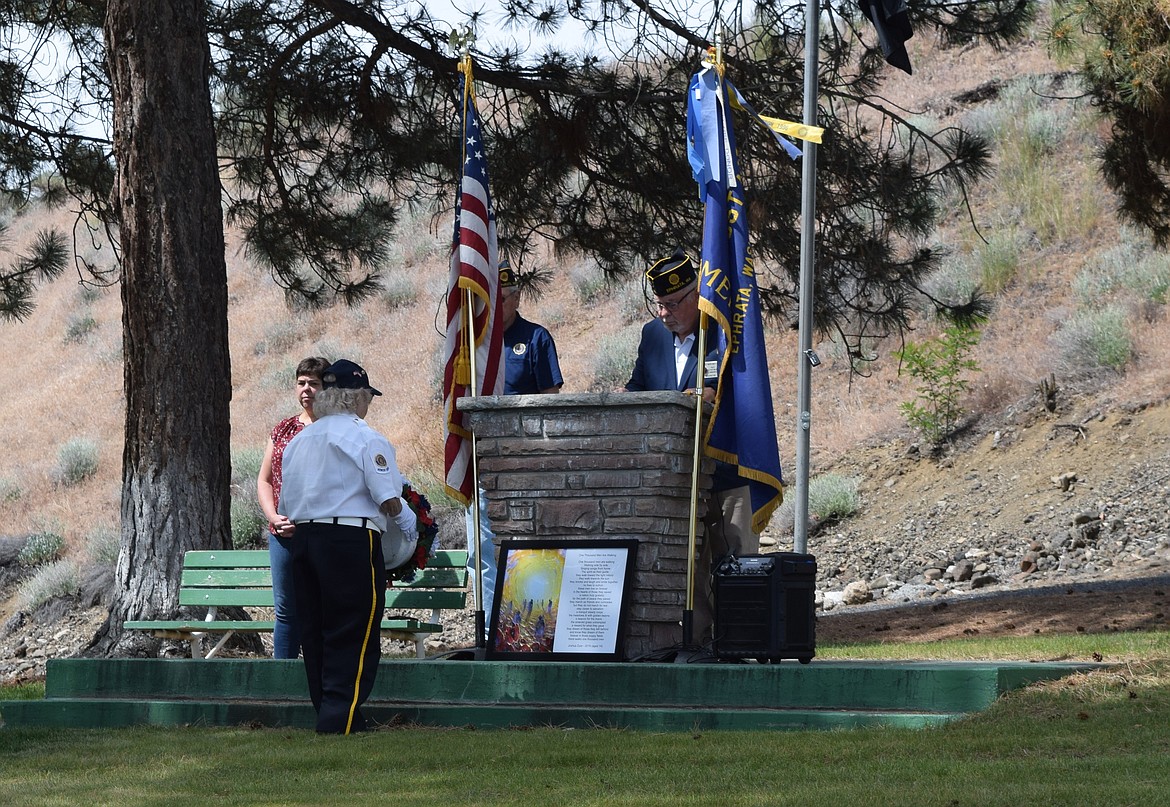 Mike Montaney with Ephrata American Legion Post 28 observes as a memorial wreath is placed at the Ephrata Memorial Day event. Memorial Day was also known as Decoration Day when it was first established after the Civil War.