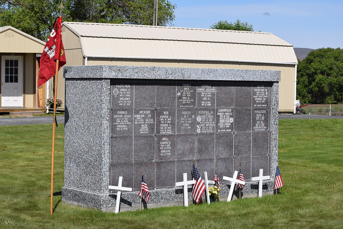 Flags and crosses line the base of a fallen veterans memorial in Soap Lake.