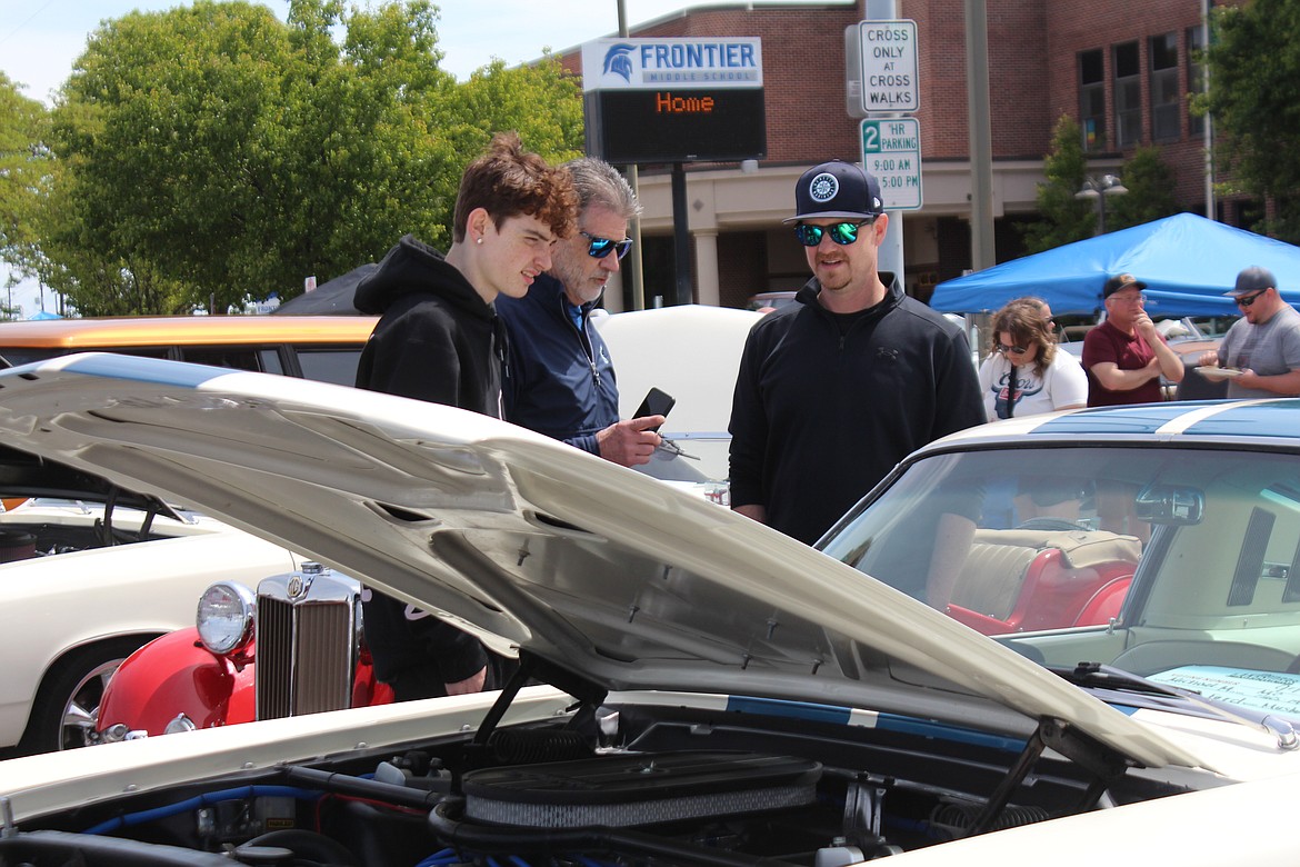 Car lovers check out the 1965 Mustang at the Spring Festival car show.