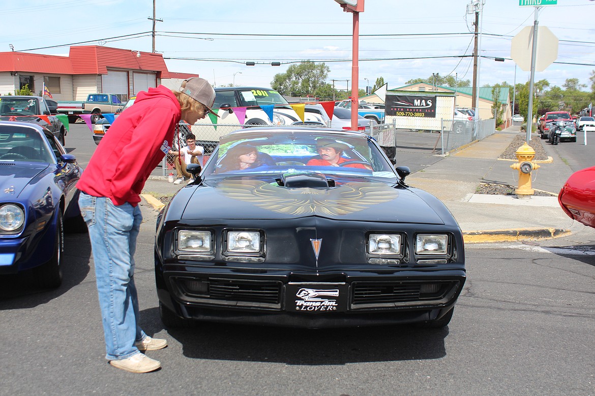 A 1977 Pontiac catches the eye of a spectator at the Spring Festival car show.