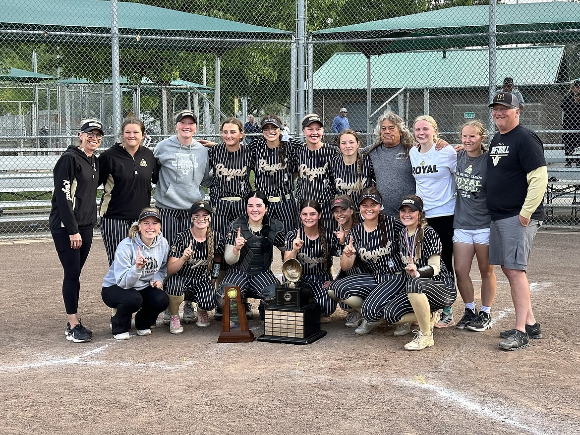 Royal players and coaches smile for photos at home plate after defeating No. 6 Seton Catholic 16-4 in the 1A State Softball Tournament’s championship game on Saturday.