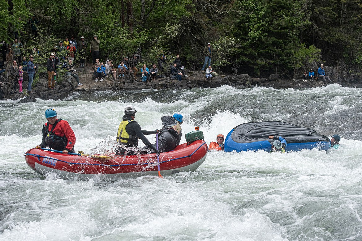 A raft flips in the second heat of head-to-head competition at the Bigfork Whitewater Festival Sunday, May 26. (Avery Howe/Bigfork Eagle)