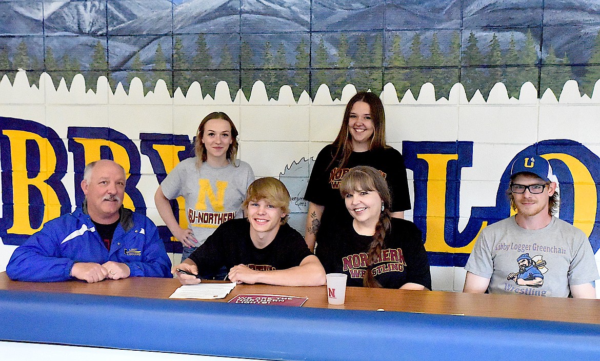 Libby Greenchain wrestler Marley Erickson, a senior at Troy High School, signs his letter of intent on Wednesday, May 29, to compete at Montana State University Northern in Havre. From left, front row, are Greenchain coach Dean Thompson, Erickson, mom Kori Erickson, and coach Garret Chapel. From left, back row, are Maicy Svendsbye, Erickson's girlfriend, and sister Rain Erickson. (Scott Shindledecker/The Western News)