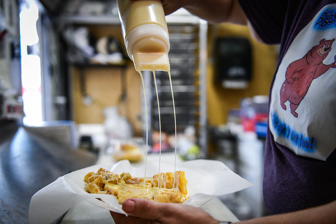 Lana Pettit drizzles a sweetened condensed milk topping onto a Thai Pancake Crisp inside the Big Sky Buttercakes food truck on Wednesday, May 29. (Casey Kreider/Daily Inter Lake)