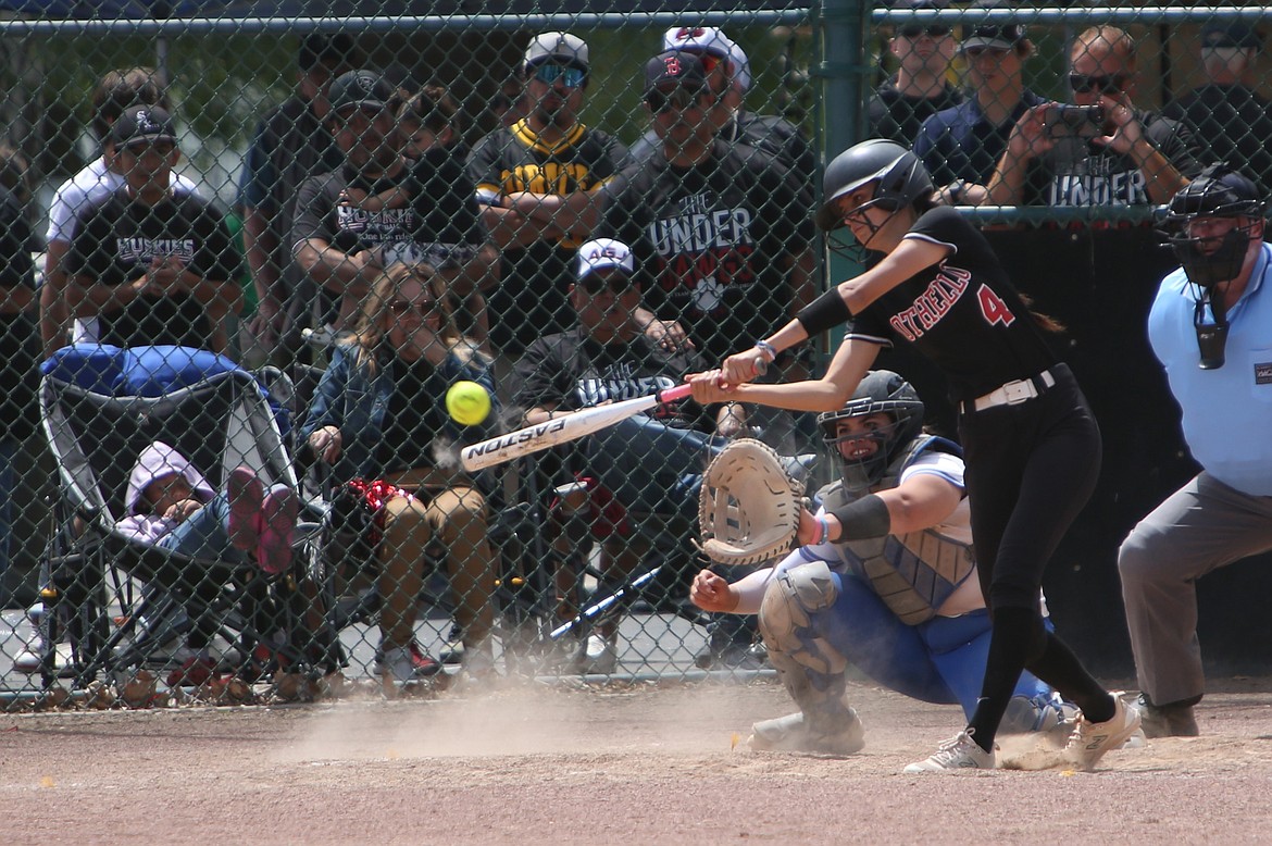 Othello senior Miccaela Valdez (4) makes contact with a pitch for a single in Friday’s 2A State Softball Tournament game against Olympic. Valdez went four-for-four at the plate in the 6-1 opening-round win.