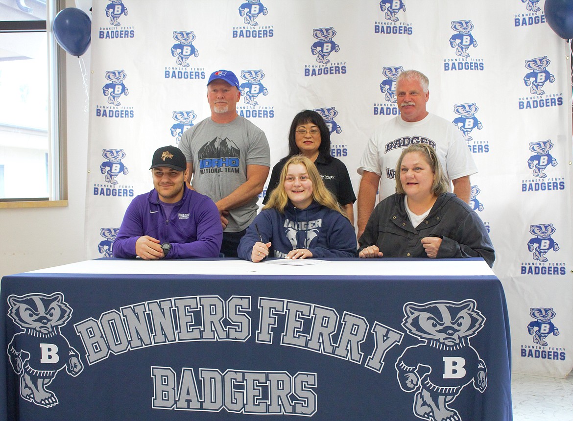 Bonners Ferry standout Savannah Rickter recently committed to continue her wrestling career on a full-ride athletic scholarship at Dickinson State University (NAIA) in Dickinson, North Dakota. Rickter is a three-time Intermountain League District 1-2 champion and led Bonners Ferry to the IML district title in 2022 (the first year the sport was sanctioned) and 2024. She is also a two-time Greco-Roman state champion, two-time Freestyle state silver medalist, three-time North Idaho Rumble champion, and has qualified for Idaho’s National Dual team since eighth grade. Rickter was sixth at the all-class Idaho girls state championship this past season and was fourth the year prior. This past winter, she received the Character and Leadership All-American Award from the National Wrestling Coaches Association and the United States Marine Corps. Before heading to college, Rickter will compete for Idaho’s National Dual Team at the Turf Wars and at Western States, both set to be held at Pocatello’s Holt Arena near the end of June. Pictured, back row, from left are Bonners Ferry High wrestling coach Corey Richards, Linda Hall and Bonners Ferry High wrestling coach Conrad Garner. Front row, from left, are Jackson Rickter (brother), Savannah Rickter and Kristie Rickter (mother).