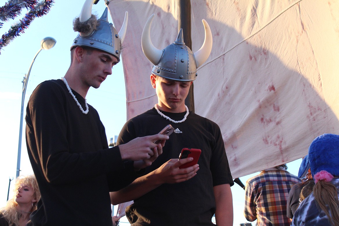 A pair of Vikings - actually part of the crew on the Sons of Norway float - check for plunder possibilities prior to the parade.