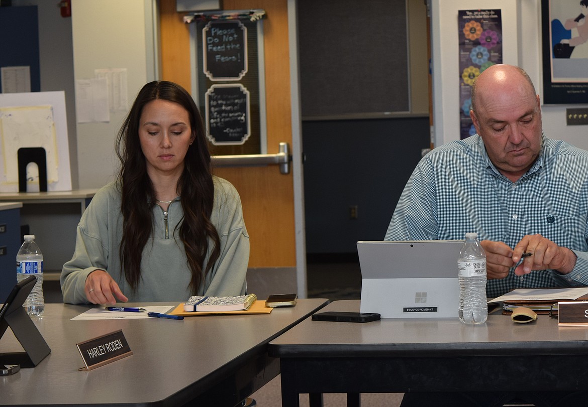 Warden School Board member Tiffany Hymas, left, listens to discussion and checks notes during the May 9 regular meeting in the Warden High School Library.