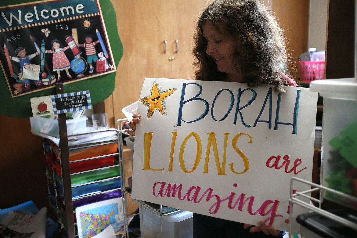 Kindergarten teacher Merrit Mitchell, who has taught at Borah Elementary for 16 years, goes through decades of stuff May 28 in the kindergarten storage area. She will follow many of her students to Bryan Elementary after Borah closes at the end of the school year.