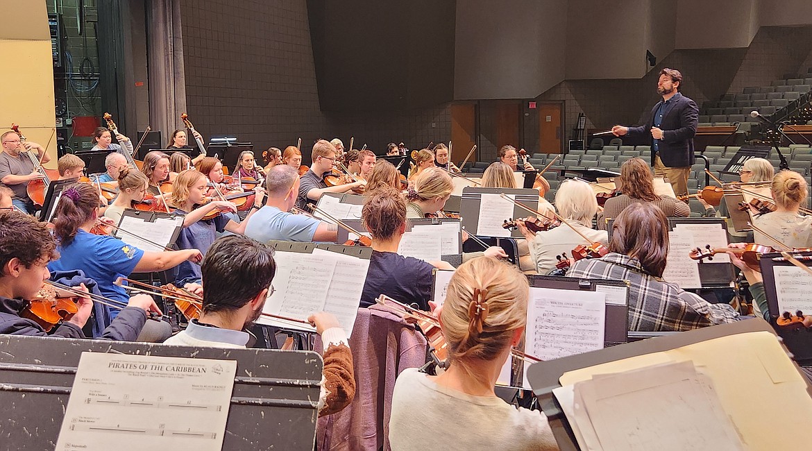 Musicians of the Coeur d'Alene Symphony Orchestra rehearse for a May performance as concertmaster Philip Baldwin conducts. A "Blazing Fiddles" benefit for the nonprofit symphony orchestra will be June 12 at Rockin' B Ranch.