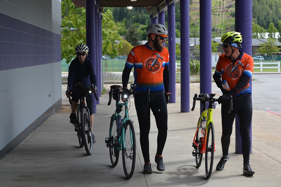 Suzanne Stack, of Arizona, Paul Richards, of Ohio and Rossie Bullock, of North Carolina, ride up to the administrative annex building of the Kellogg School district, where they spent the night before assisting with home projects through The Fuller Center.