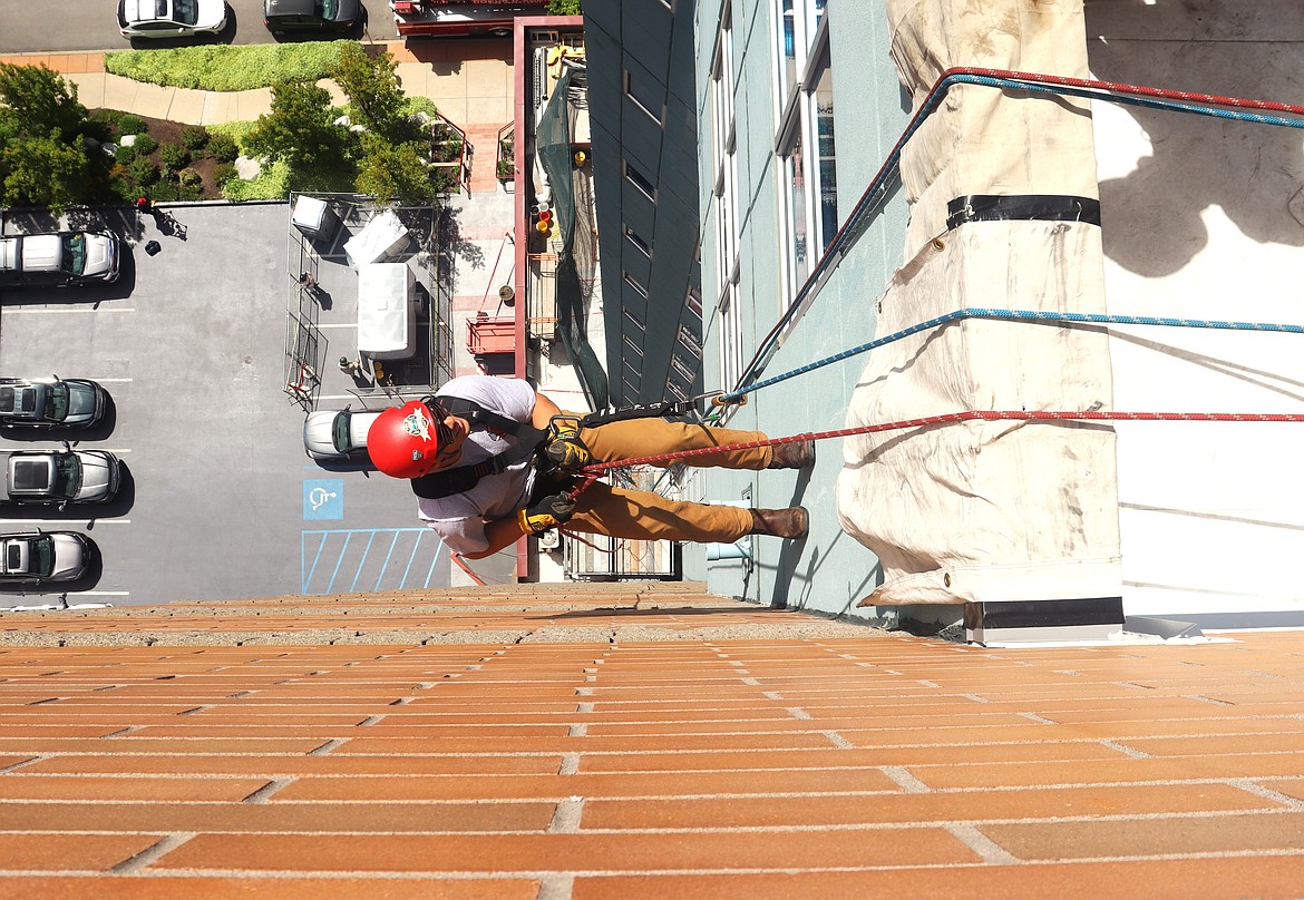 Coeur d'Alene firefighter Max McCormick rappels down McEuen Terrace during rescue training on Thursday.