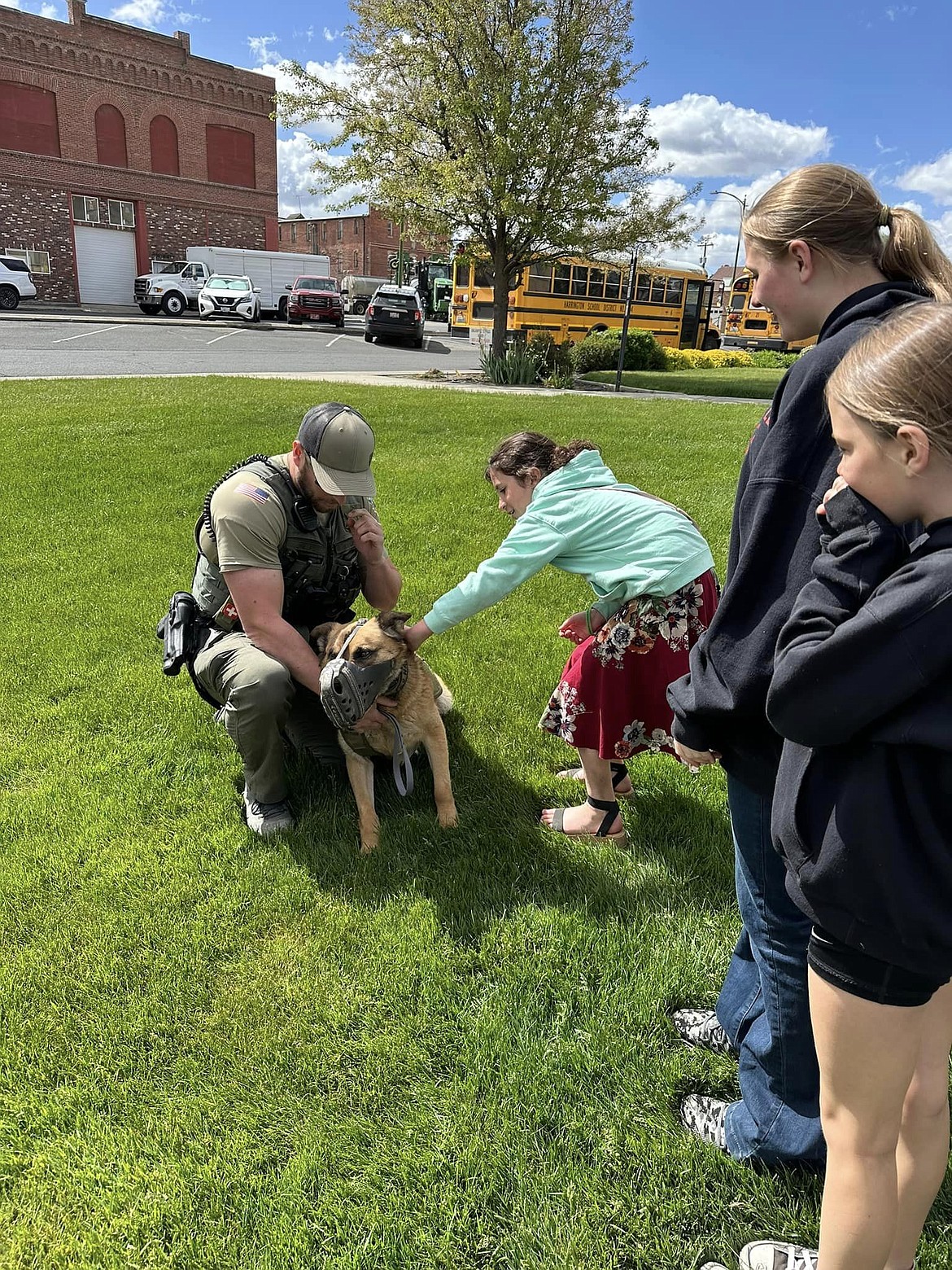 A student says hello to K9 Nado during Law Day on May 17 in Ritzville. The event gives officers from the Adams County Sheriff’s Office, Ritzville Police Department and Washington State patrol a chance to interact with students.