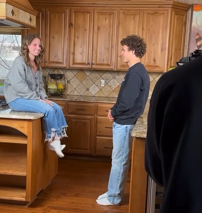 Kyle Rohlinger and Sydney Jacobson are pictured in this still from behind-the-scenes footage of Sydney's debut music video featuring the song "Girl You Call a Friend."