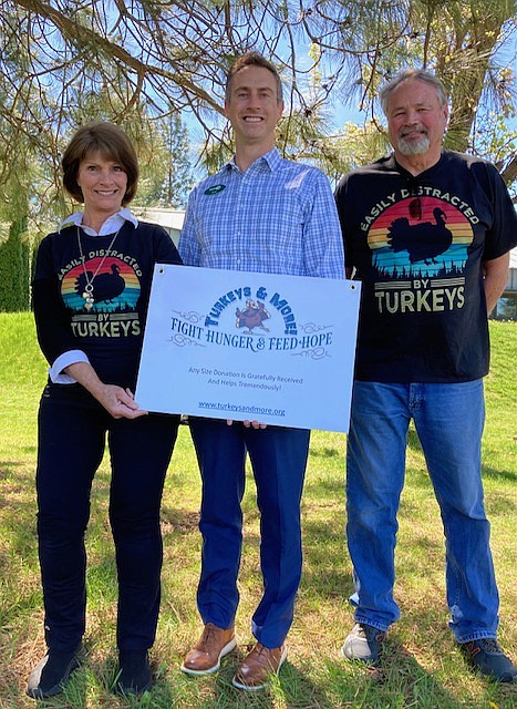 Brad Rasor of bankcda continued their support to buy Thanksgiving turkeys by donating $500 recently to Turkeys & More. He emphasized the importance of helping financially stressed families during this holiday season and was pleased to be able to assist with the November distribution of 2,000 turkeys to 20 food banks and service agencies in Kootenai County. Turkeys & More Founder Evalyn Adams said other folks who would like to help this important cause may send checks to Turkeys & More, P.O. Box 267, Coeur d'Alene, ID 83816; or donate safely online at TurkeysandMore.org. The nonprofit appreciates donations now in order to confirm best price for ordering the birds in early summer. Pictured are Turkey Team members Dolly Studebaker and Jerry Flowers, with Brad Rasor in the middle.