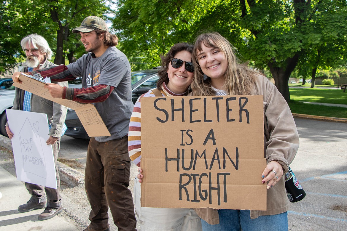 Flathead Valley residents Cam Mahnken and Anne Marie Lambert hold a sign at a rally in support of the Flathead Warming Center on May 30, 2024. (Kate Heston/Daily Inter Lake)