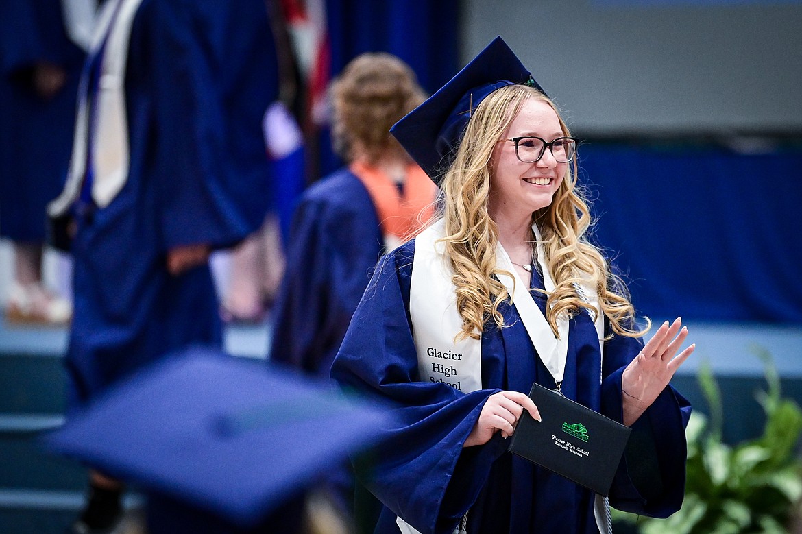 A graduate waves to the crowd after receiving her diploma at the Glacier High School class of 2024 graduation ceremony on Saturday, June 1. (Casey Kreider/Daily Inter Lake)