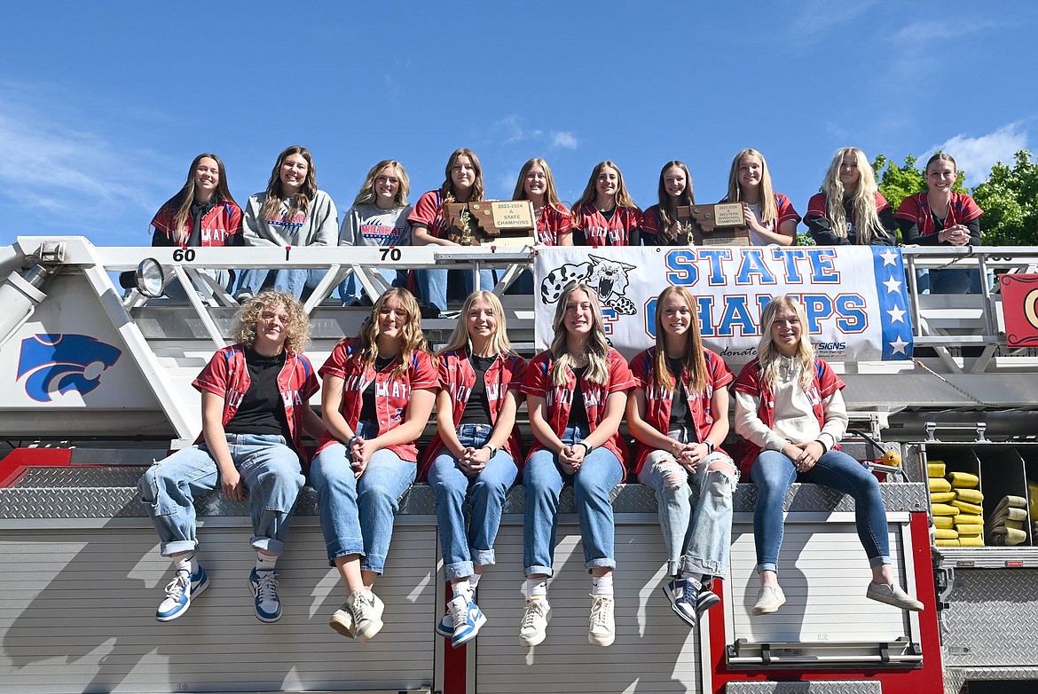 The Columbia Falls softball team poses on a fire truck before a parade through town Tuesday. (Chris Peterson photo)