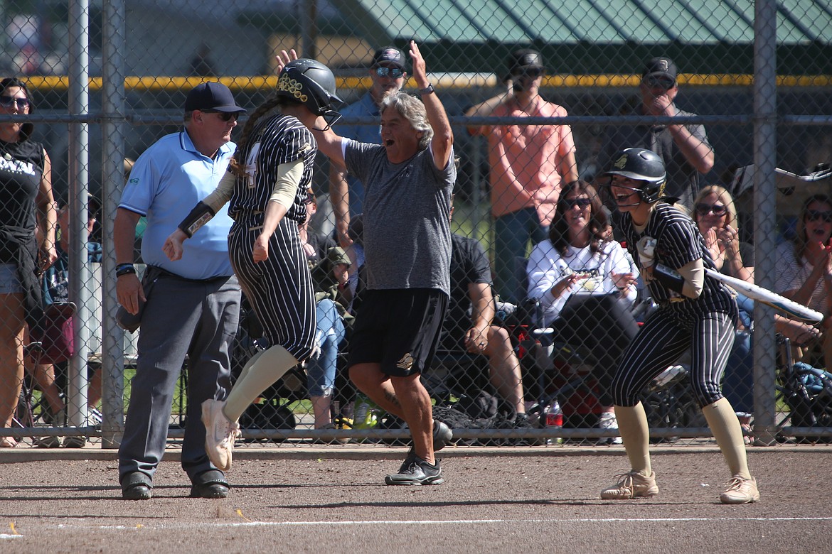 Royal seniors Raegan Wardenaar (4) and Jaya Griffin, right, celebrate after scoring a run during Royal’s 10-0 win over Klahowya at the 1A State Softball Tournament in Richland. The Knights won the state championship this spring.