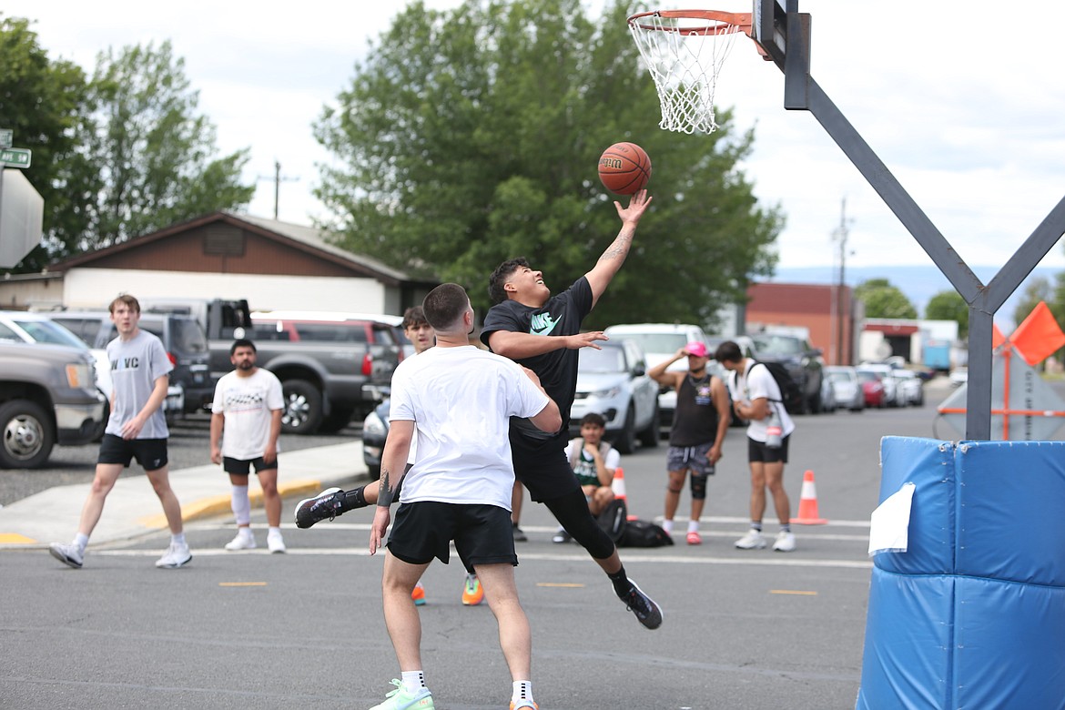 A player drives toward the hoop for a layup at Saturday’s Dru Gimlin 3-on-3 Basketball Tournament in Quincy.