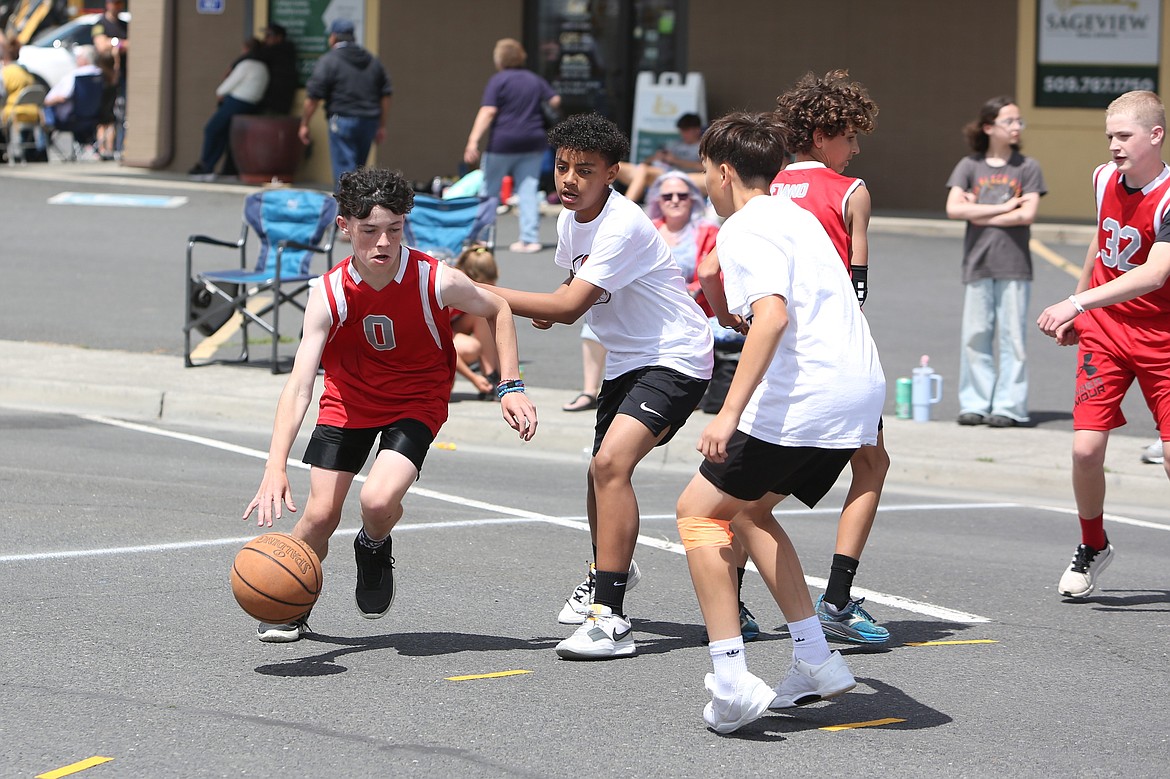 A player looks to make a move while being defended during Saturday’s Dru Gimlin 3-on-3 Basketball Tournament in Quincy.