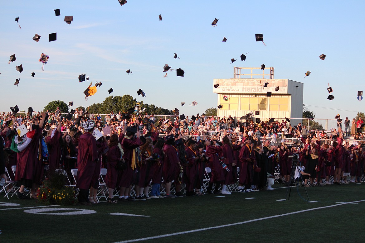 Graduation caps fly through the air at the end of the ceremony for Moses Lake High School seniors Friday night.