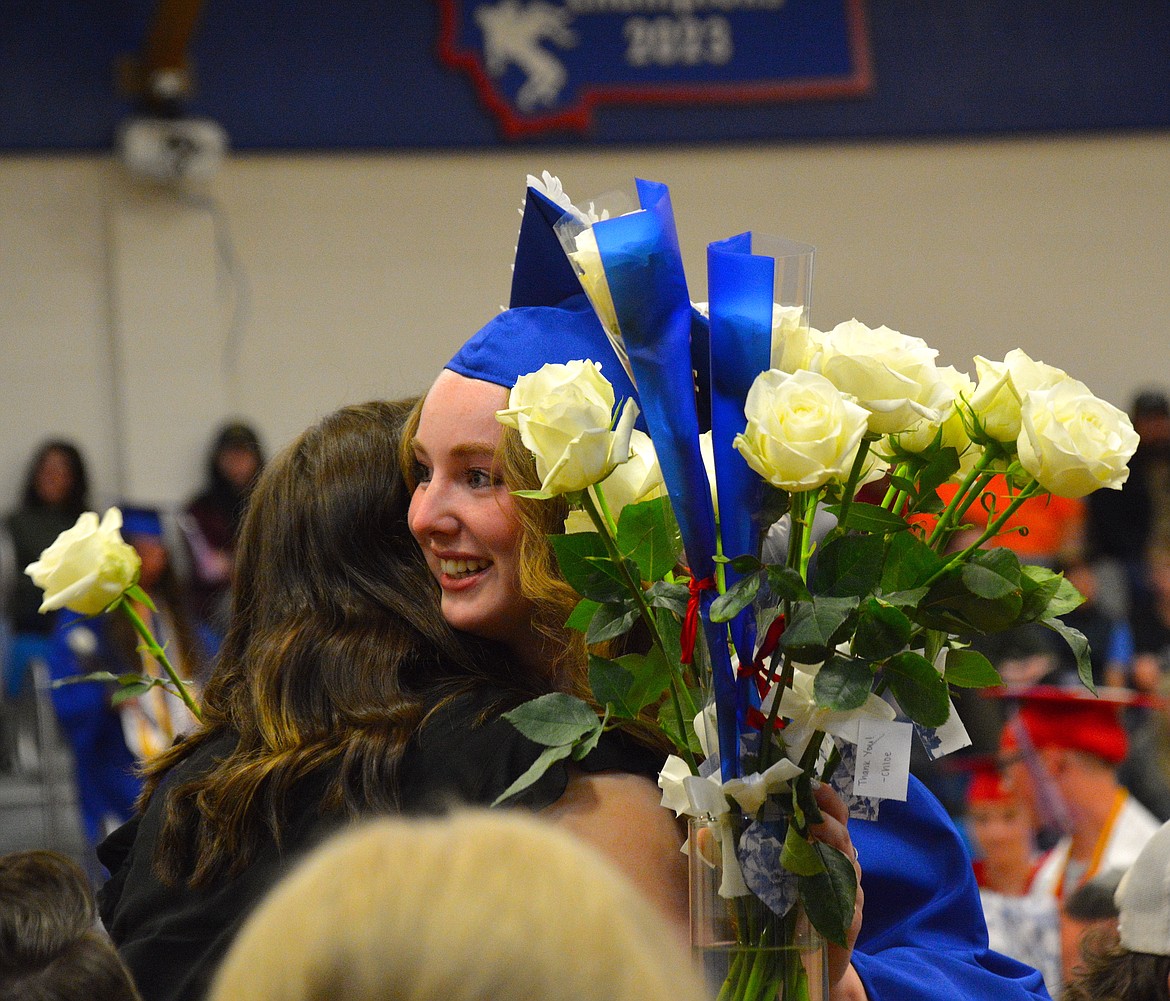 Chloe Williams hugs a family member and gives them a flower as a token of appreciation during the rose presentation at the Superior High School Graduation ceremony. (Mineral Independent/Amy Quinlivan)