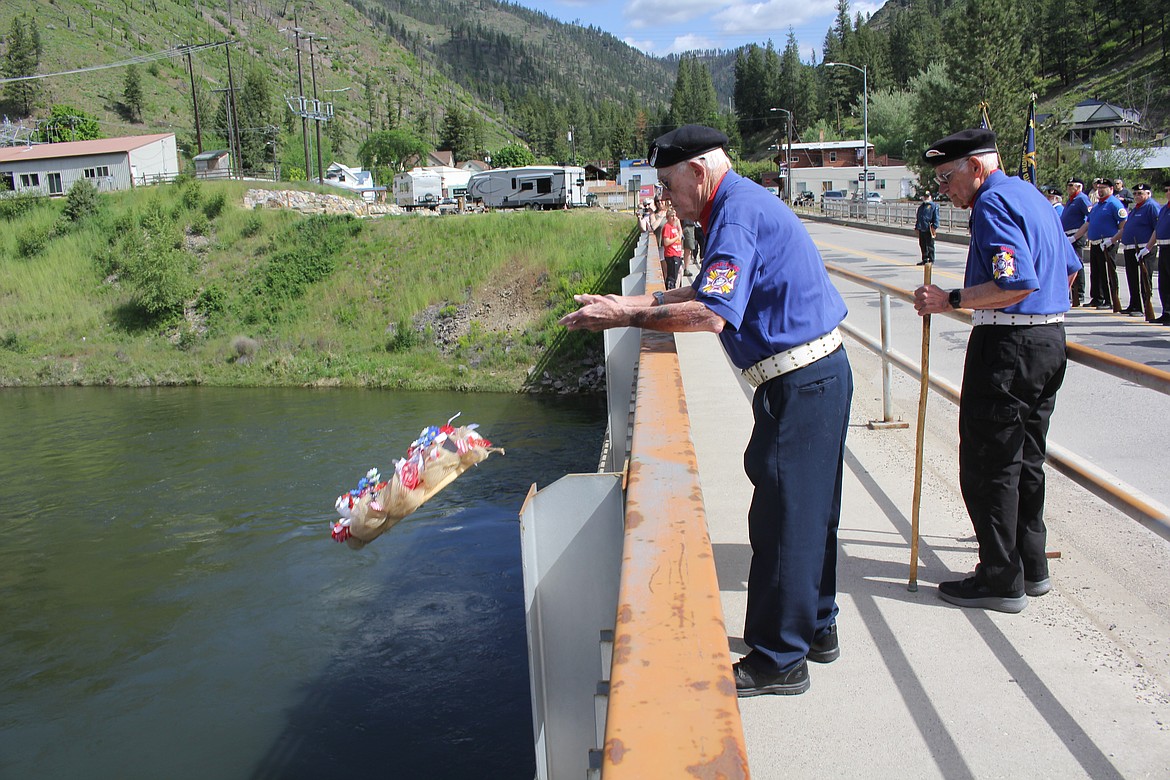 VFW member Doug Cummings releases the wreath into the Clark Fork River from the Veterans Bridge in Superior for the closing of the Memorial Day service. Jim DeBree stands with Cummings as the Honor Guard completed the 21-gun salute and taps had been played.