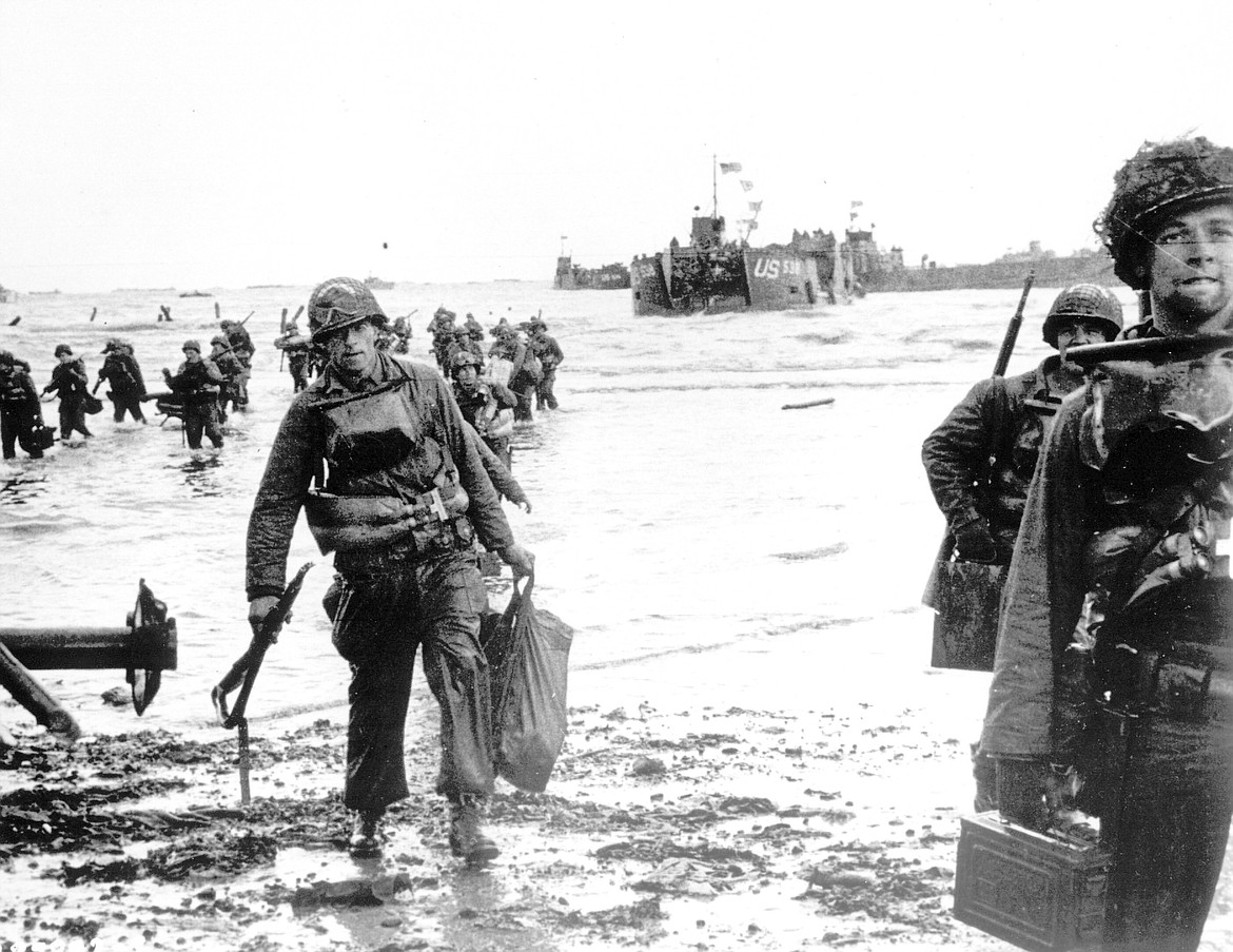 Carrying full equipment, American assault troops move onto a beachhead code-named Omaha Beach, on the northern coast of France on June 6, 1944, during the Allied invasion of the Normandy coast. The greatest armada ever assembled, nearly 7,000 ships and boats, supported by more than 11,000 planes, carried almost 133,000 troops across the Channel to establish toeholds on five heavily defended beaches stretched across 80 kilometers (50 miles) of Normandy coast. More than 9,000 Allied soldiers were killed or wounded in the first 24 hours. (U.S. Army via AP, File)