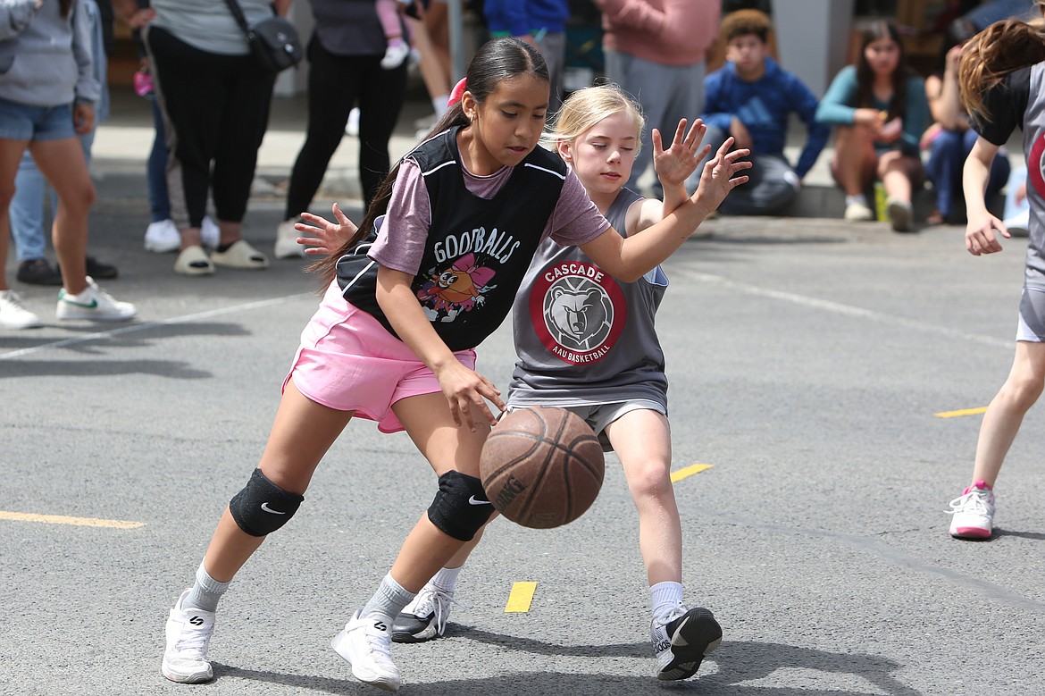 A player from Cascade defends a driving player during a game at Saturday’s Dru Gimlin 3-on-3 Basketball Tournament in Quincy.