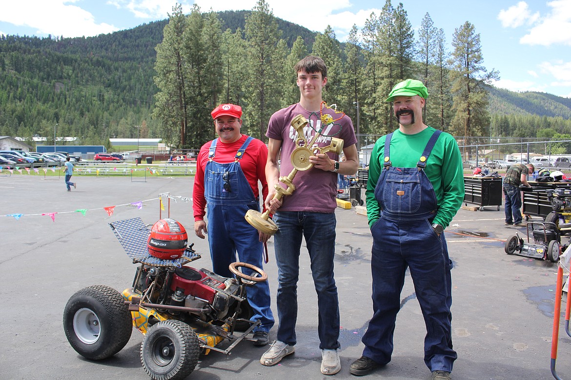 Landon Richards between the Mario Brothers with his trophy for first place. Chris Clairmont is in red, with small engine repair instructor Matt Doughty. The decision to make this an annual event before school is out for the summer was well received by all. (Monte Turner/Mineral Independent)