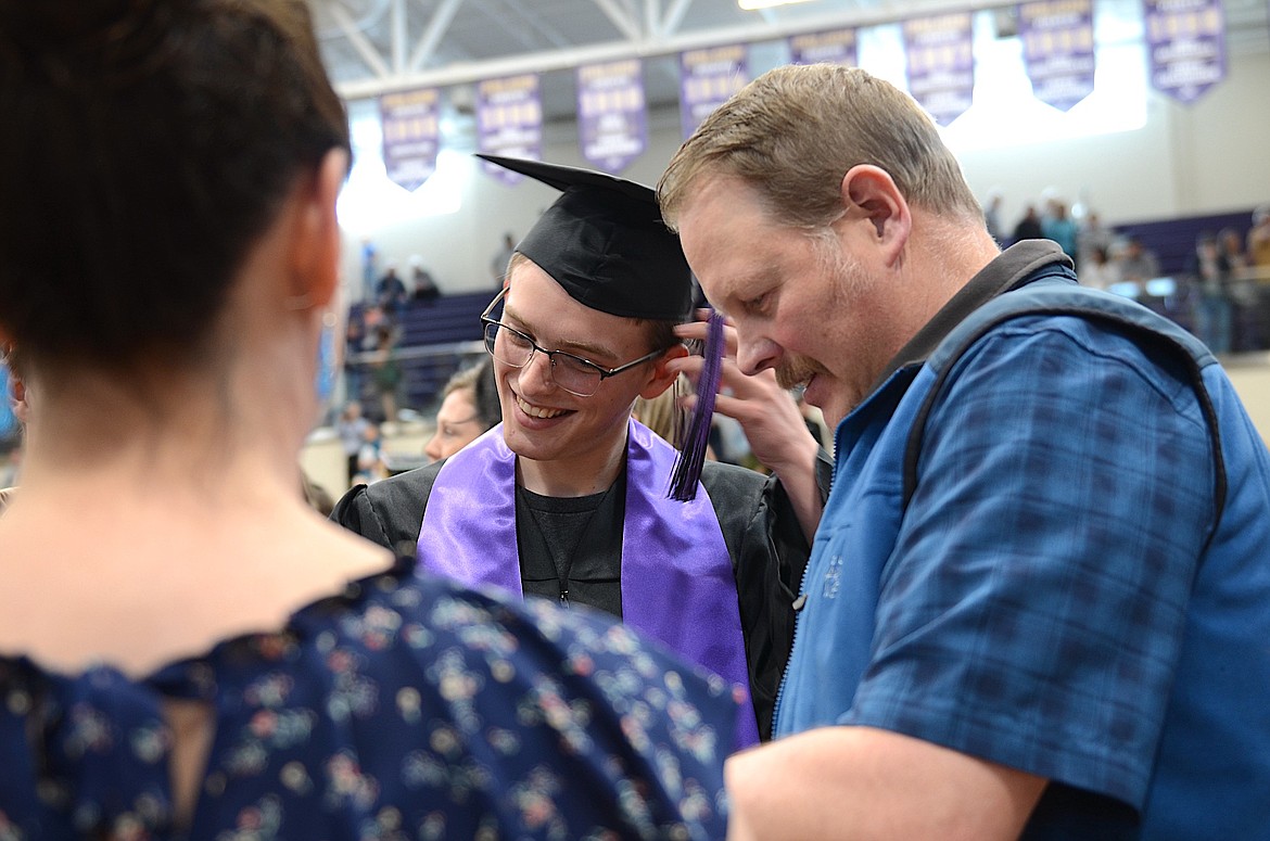 Jake Feistner checks out the diploma received Saturday by his son, Polson High grad Justus Feistner. (Kristi Niemeyer/Leader)