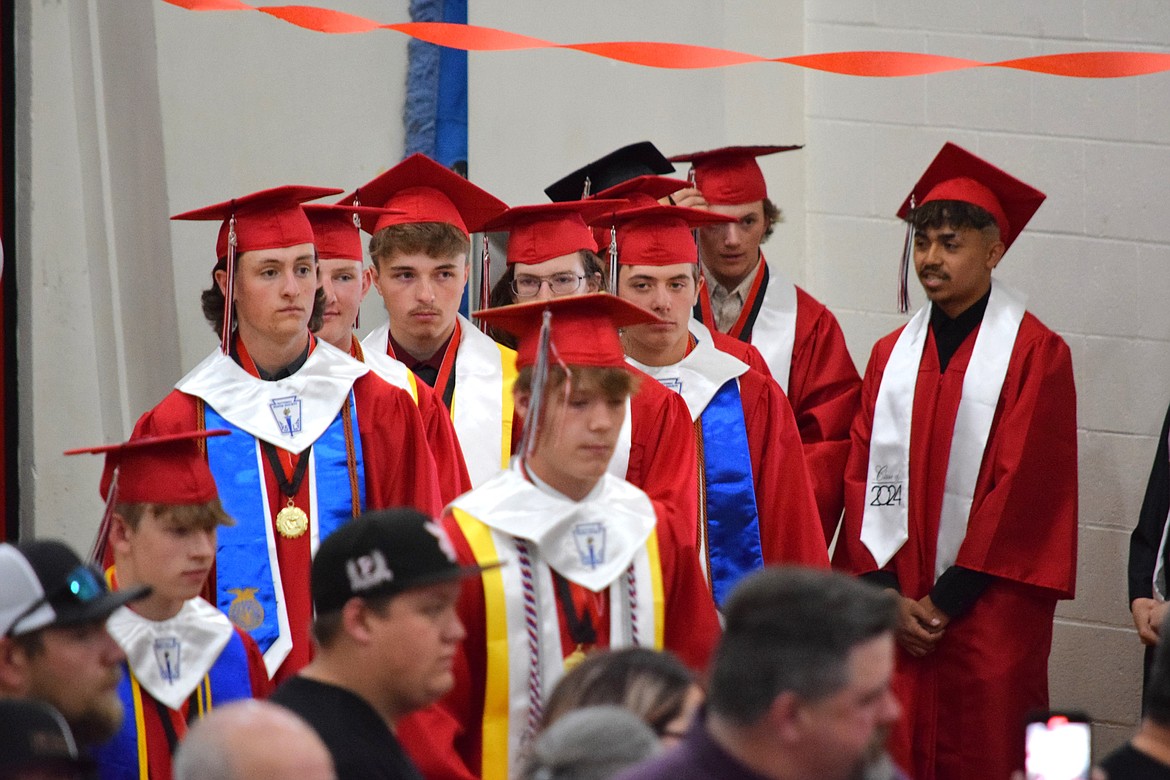 Lind-Ritzville graduating seniors begin walking toward the stage as part of the processional at the beginning of Saturday’s Class of 2024 commencement ceremony.