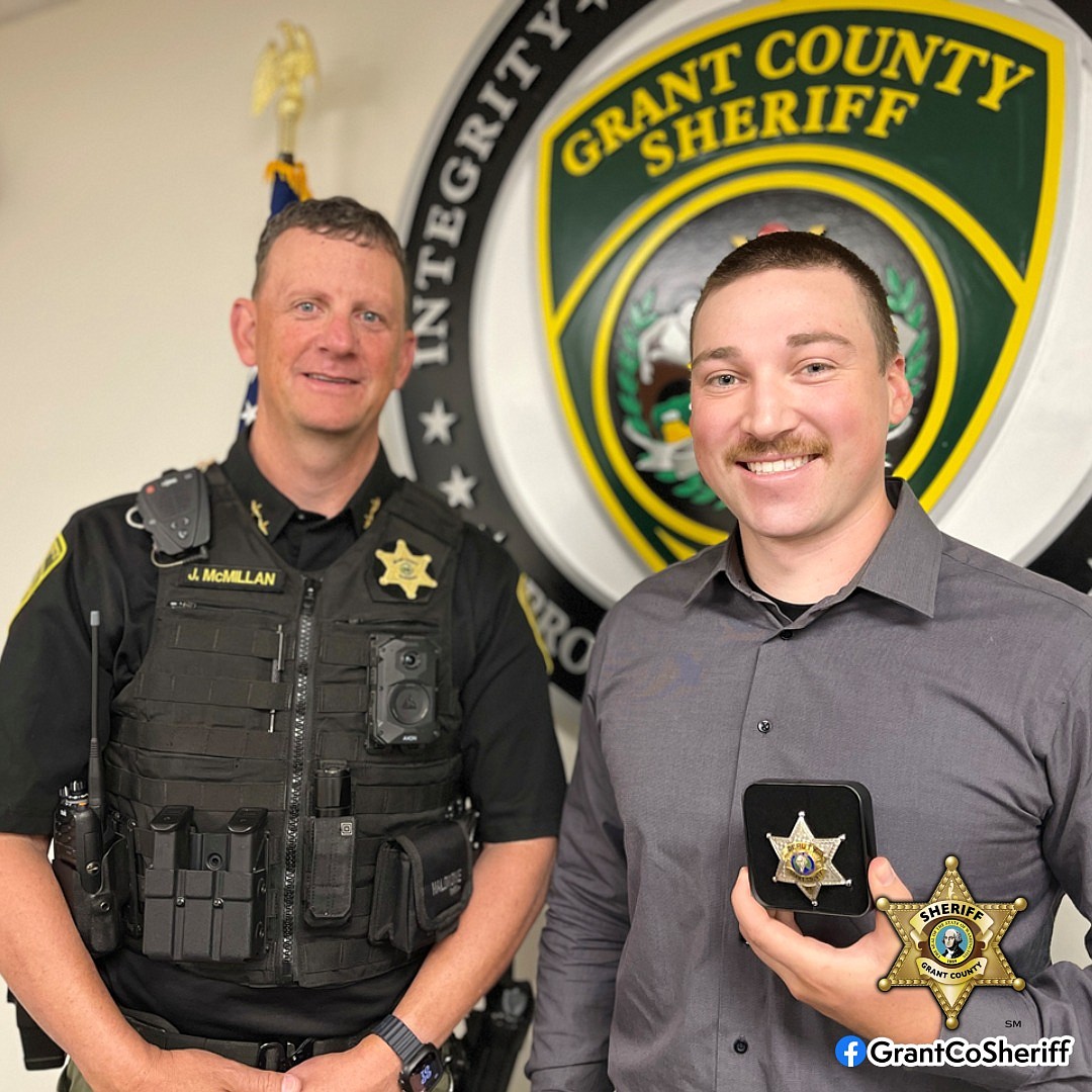 Undersheriff John McMillan, left, administered the oath of office to Corrections Deputy Mason Boyes, right, Monday morning.