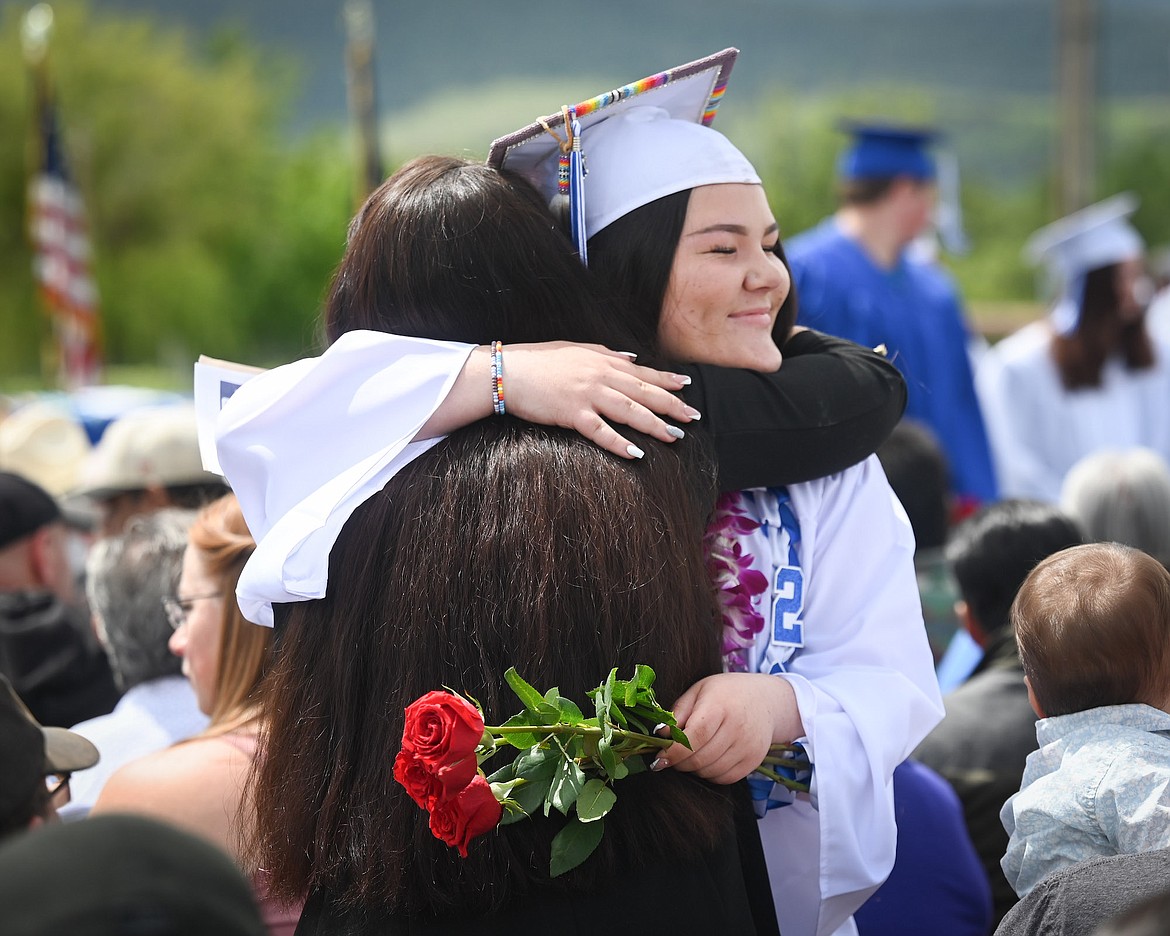 Paisley Couture gives her mom, Gwen Couture, a hug and a rose during graduation ceremonies Saturday in St. Ignatius. (Christa Umphrey photo)