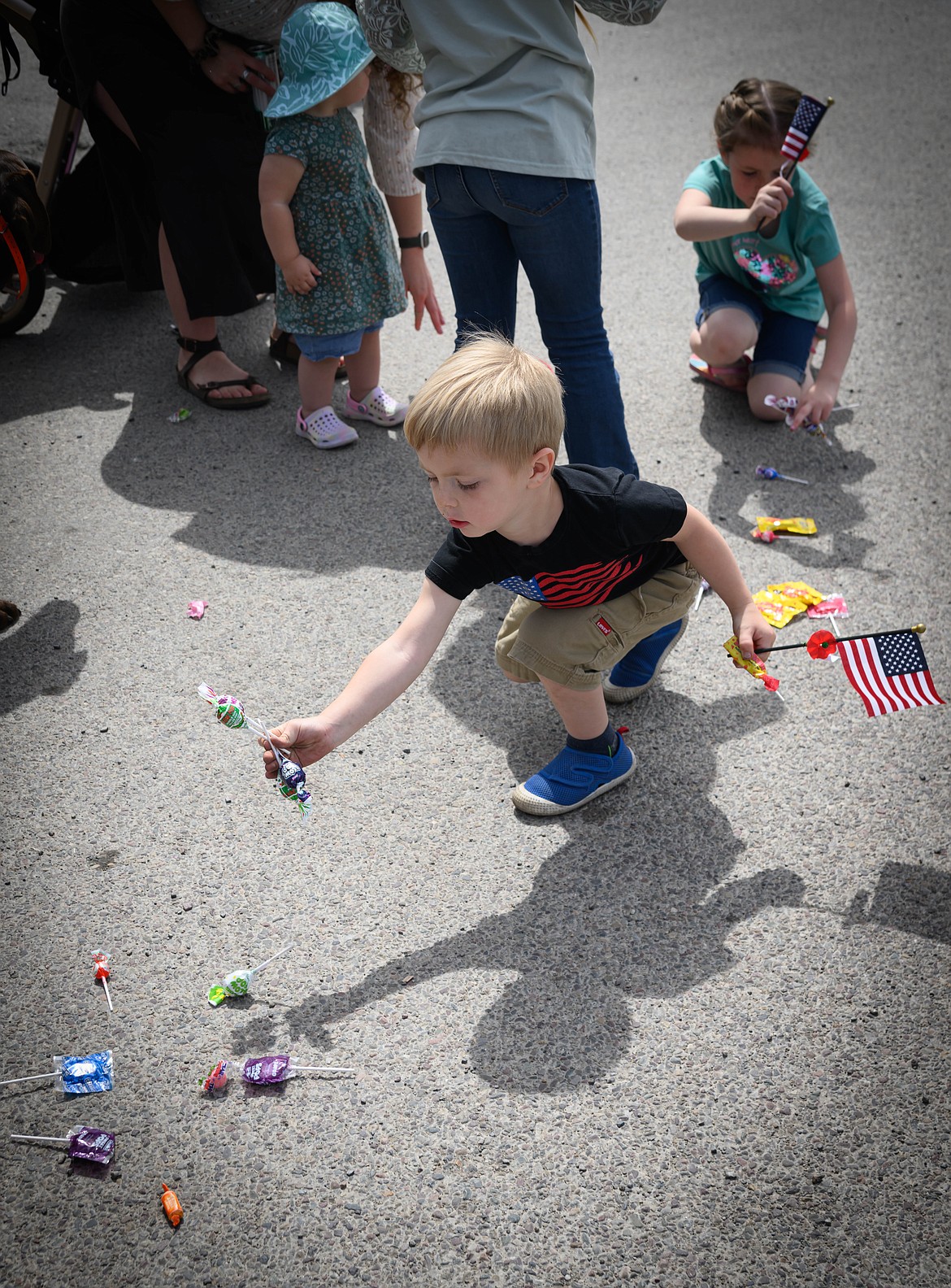 Atreyu Gallaway, 3, grabs candy thrown during the parade. (Tracy Scott/Valley Press)