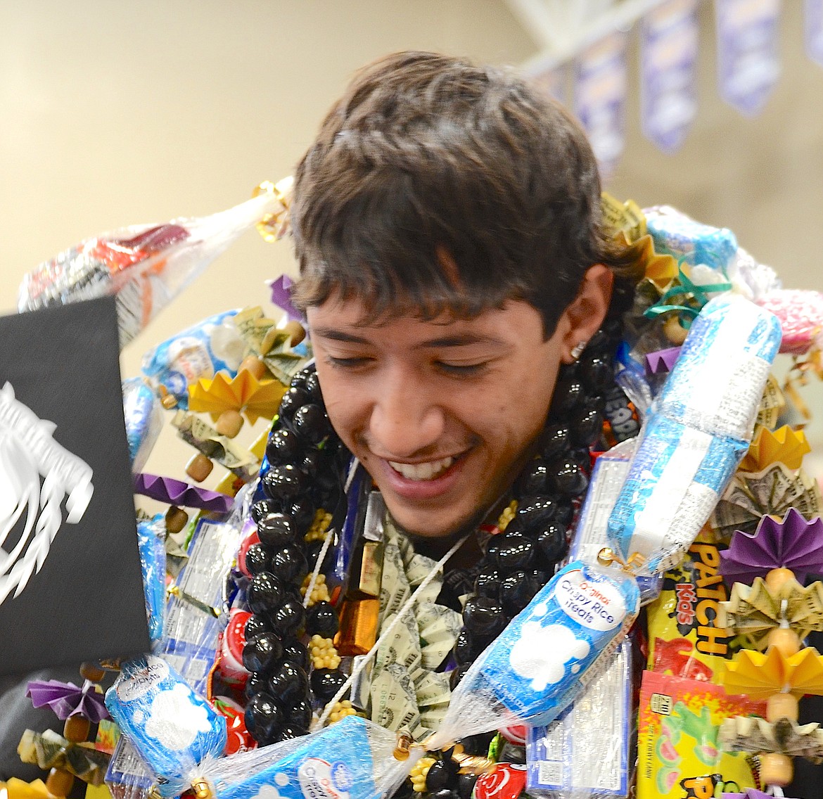 The graduation of Polson's Uriah Ulutoa was celebrated with layers of leis, presented by family and friends Saturday. (Kristi Niemeyer/Leader)