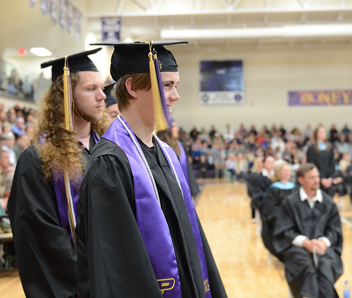 PHS graduates Gus Hertz and Brant Heninger head to the stage to accept their diplomas Saturday. (Kristi Niemeyer/Leader)