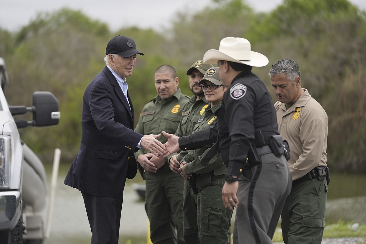 President Joe Biden talks with the U.S. Border Patrol and local officials, as he looks over the southern border, Feb. 29, 2024, in Brownsville, Texas, along the Rio Grande. Biden's migration order aims to shut down asylum requests at US-Mexico border if illegal crossings average 2,500 per day. (AP Photo/Evan Vucci, File)