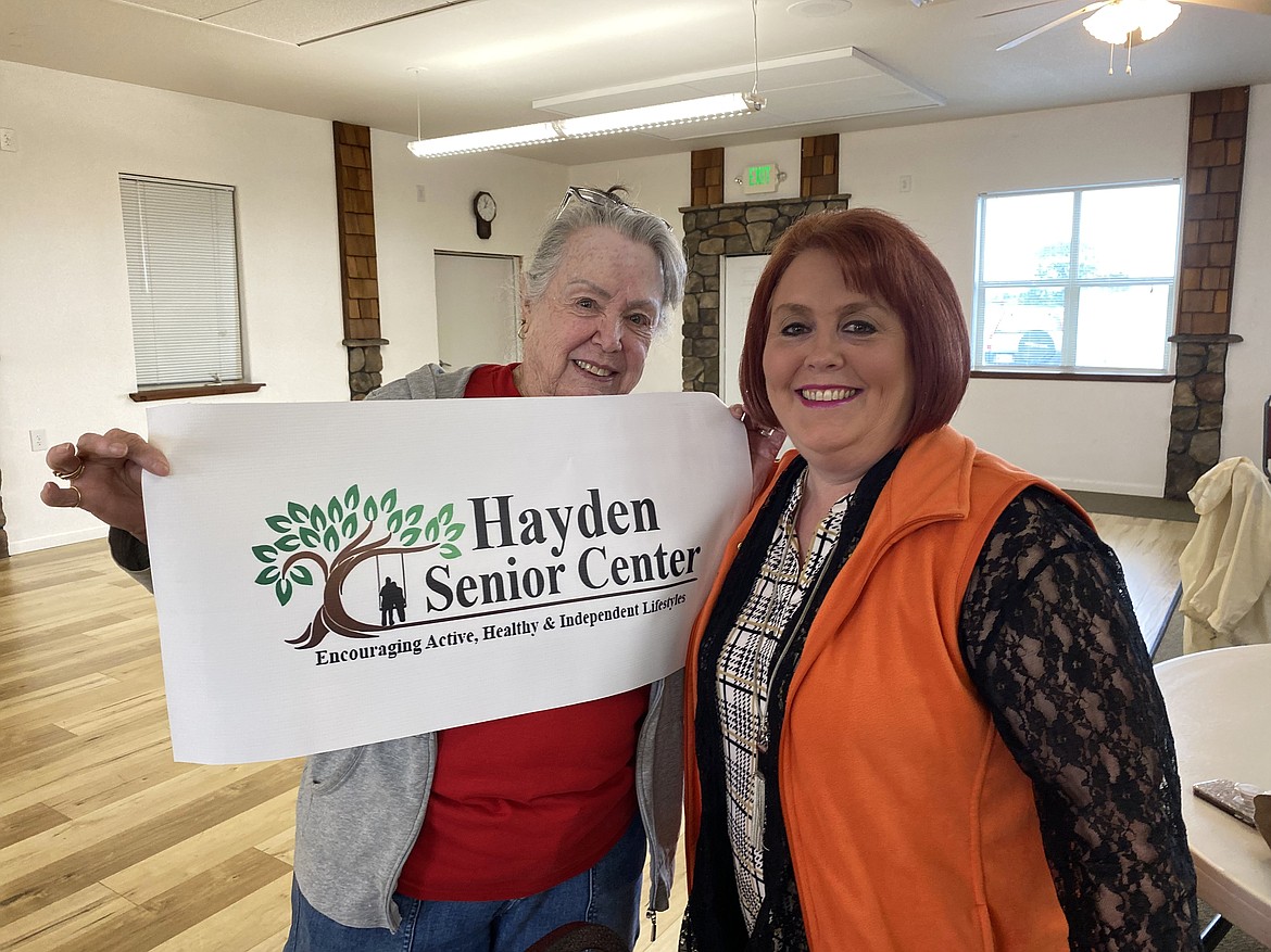 Kathy Verburg, Hayden Senior Center chairman, and Andrea Fulks, president and CEO of the Hayden Chamber of Commerce celebrate the reentering of the senior center to the chamber of commerce Tuesday.