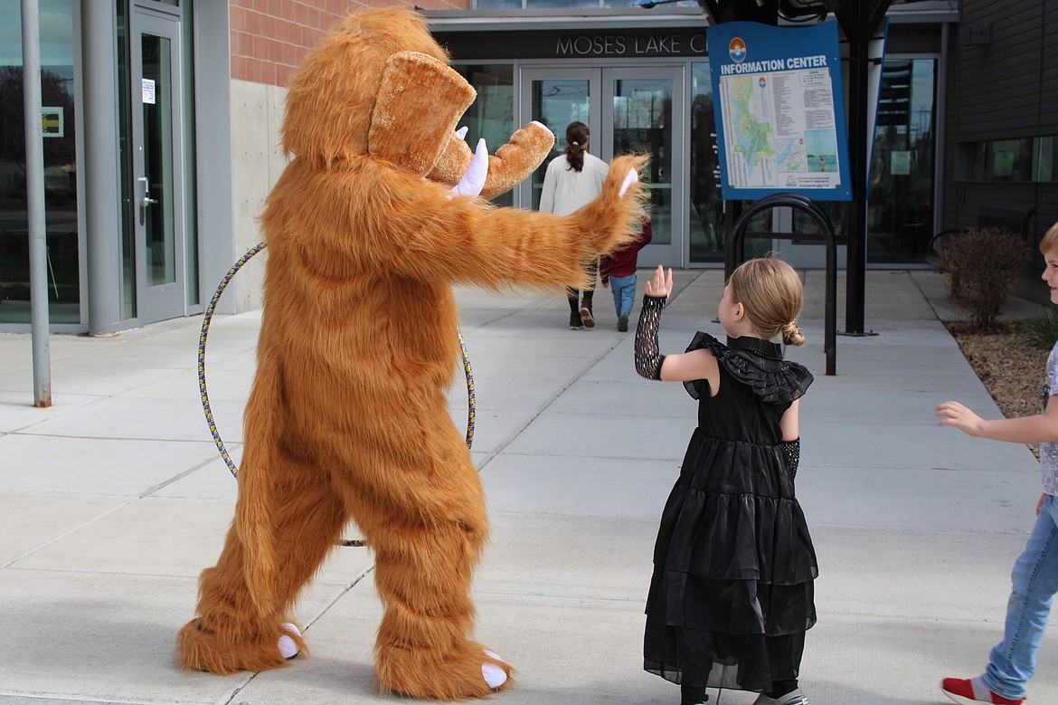 The Moses Lake Museum & Art Center mammoth gives a high-five to a museum visitor. Activities at the museum this summer include a photo contest.