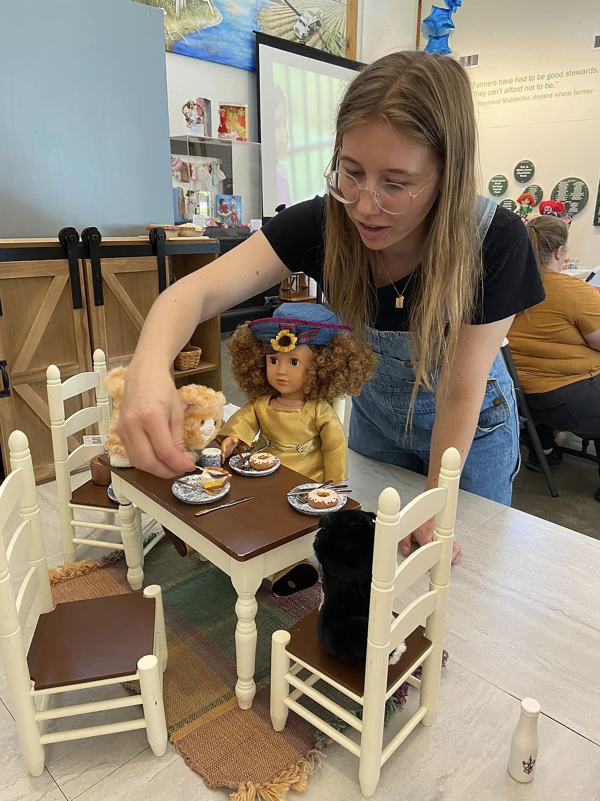 A participant serves up tea with a doll at the Quincy Valley Museum Toys through Time in 2023. Toys through Time 2024 will feature a farm theme