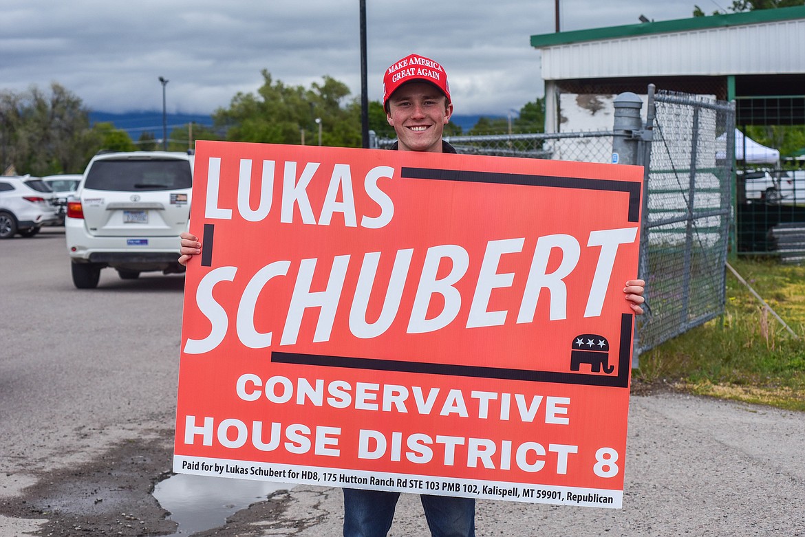 Republican candidate Lukas Schubert, running against incumbent Republican Tony Brockman in House District 8, campaigns at the entrance to the Flathead County Fairgrounds on June 4, 2024. (Kate Heston/Daily Inter Lake)