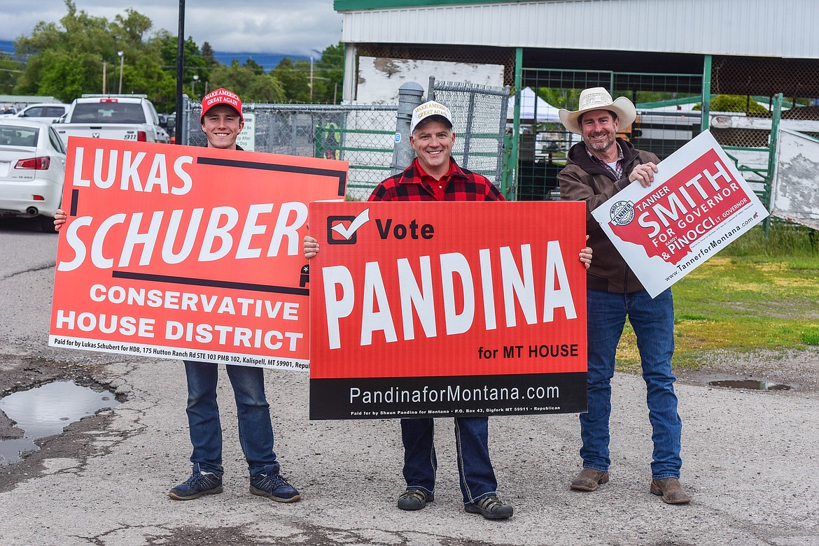 Republican congressional candidates Lukas Schubert, left, Shaun Pandina, center, and gubernatorial Republican candidate Tanner Smith's campaign manager, Jim Riley, campaign at the entrance to the Flathead County Fairgrounds on June 4, 2024. (Kate Heston/Daily Inter Lake)