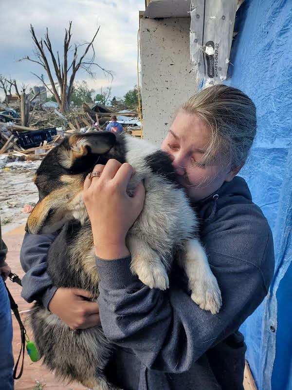 Haley Williams holds one of her dogs that survived the May 21 tornado in Iowa.