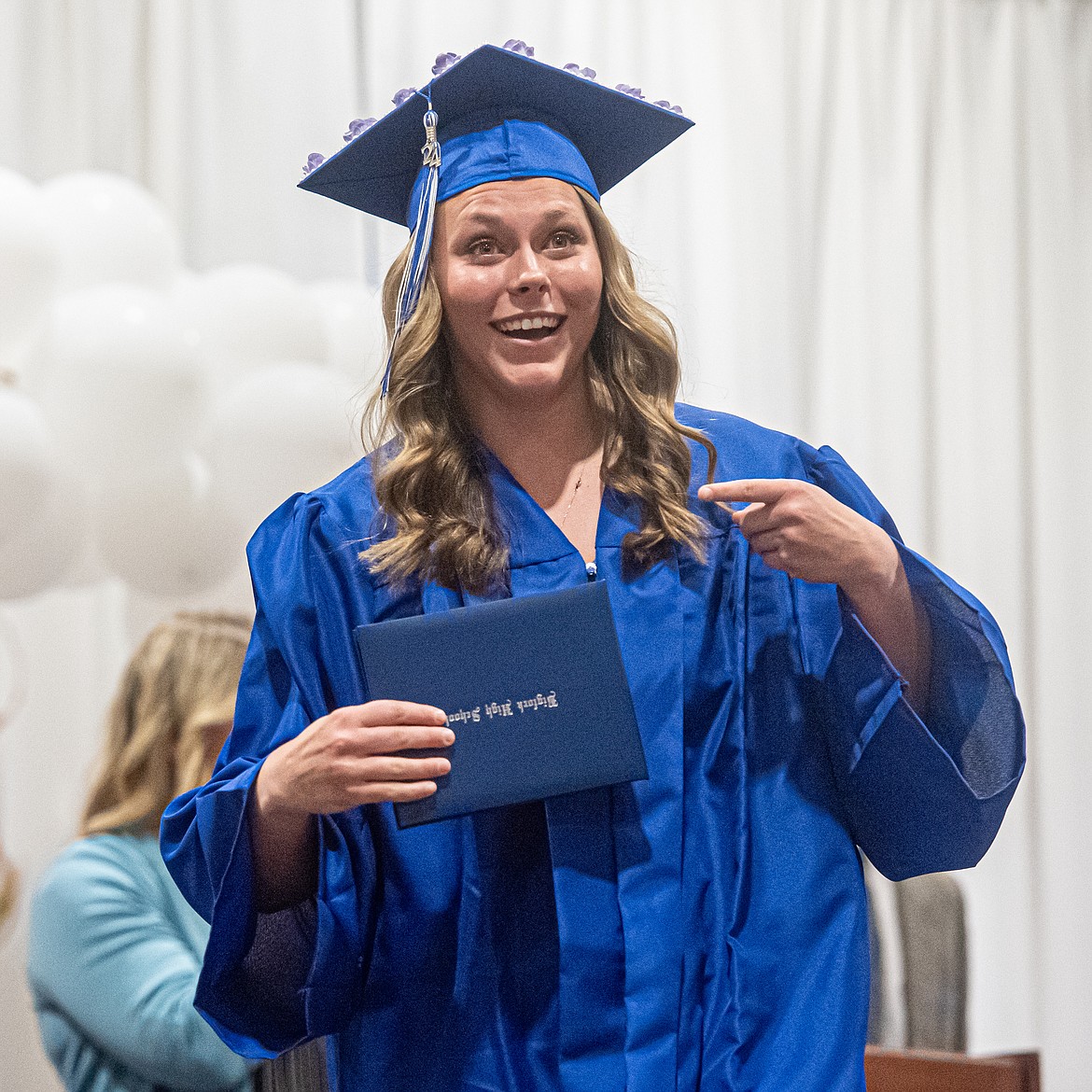 Afton Lambrecht shows off her new diploma.