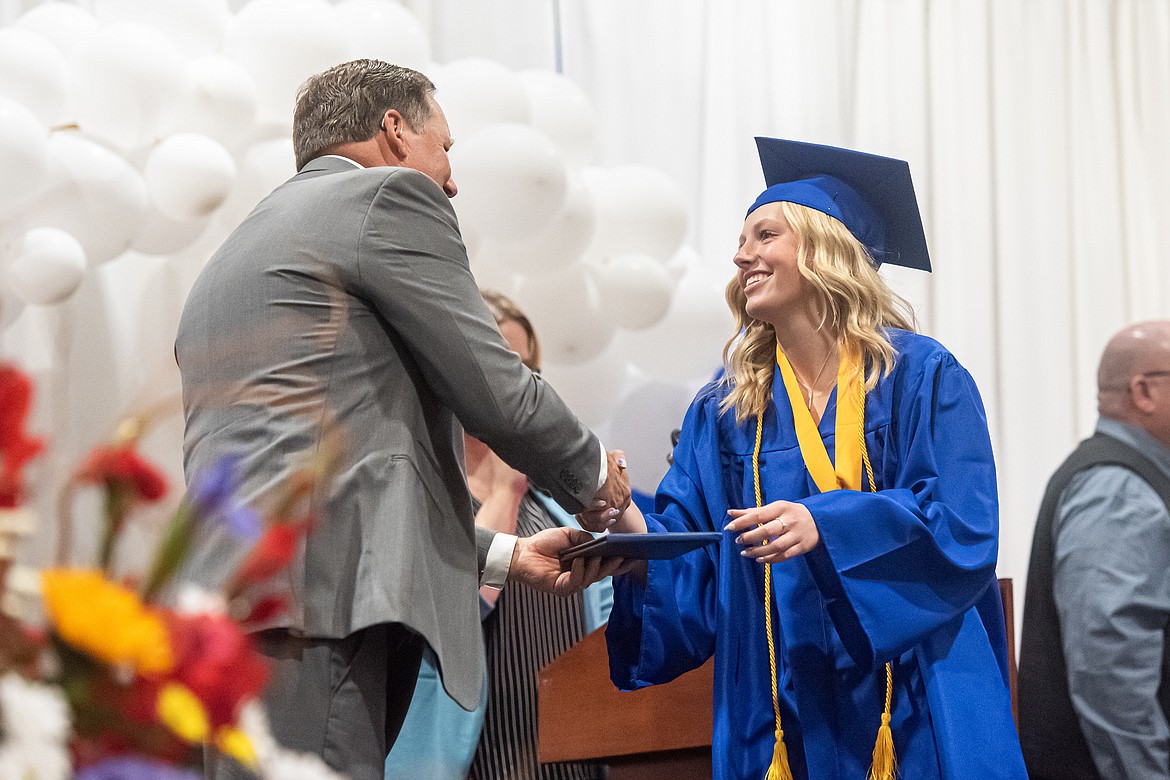 Piper Linson receives her diploma from principal Mark Hansen.